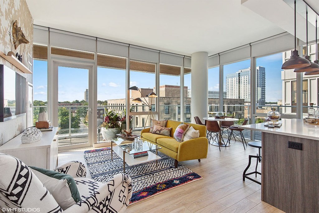 a living room with a view of the city and a yellow couch