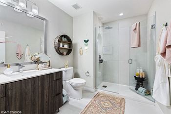 a bathroom with a shower and a sink and a toilet