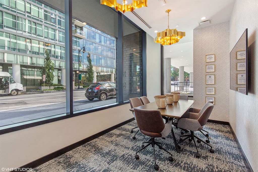 a conference room with large windows and a table with chairs