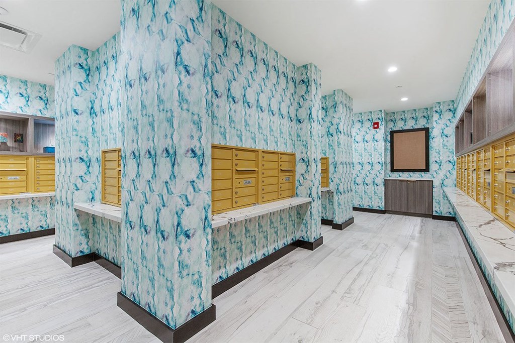 a locker room in a gym with blue cabinets and wooden benches