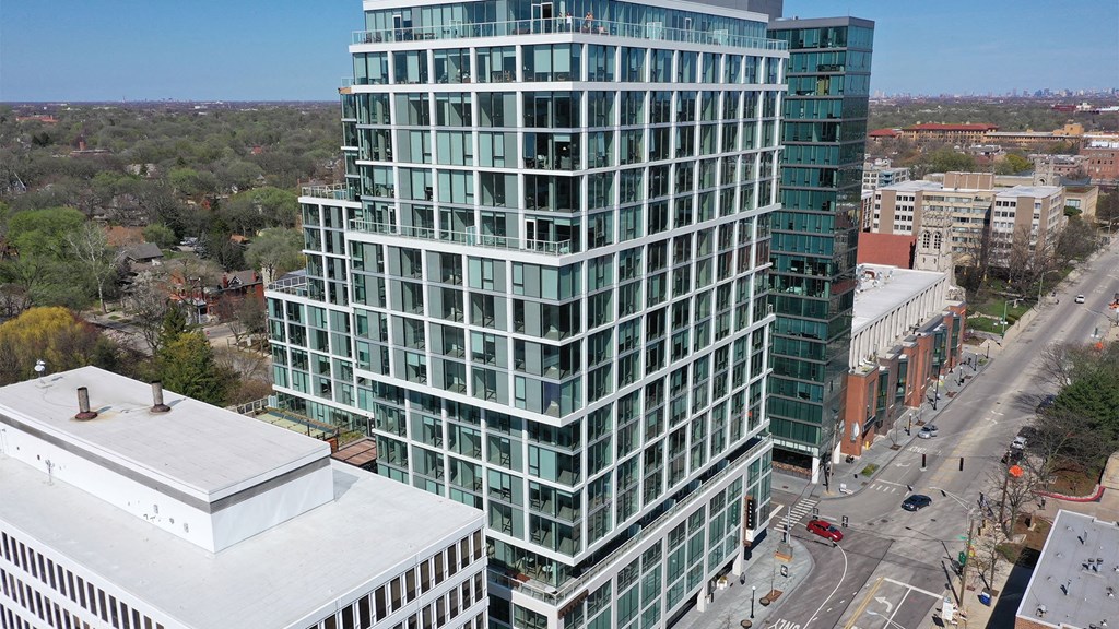 an aerial view of a tall building in a city