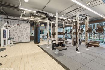a gym with weights machines and other gym equipment in a building