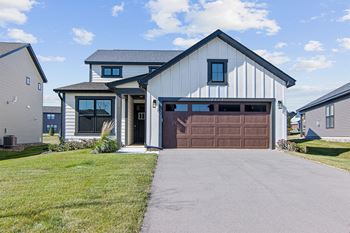 a house with a brown garage door and a driveway