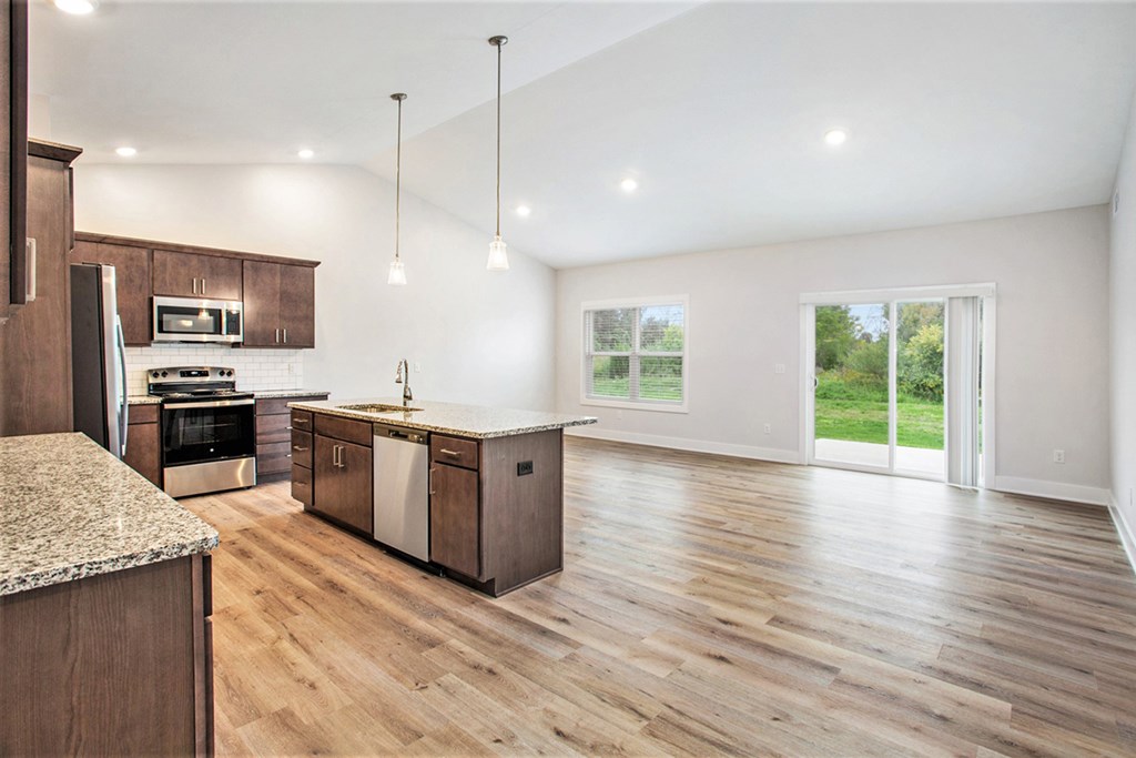 A kitchen with wooden floors and a large island.