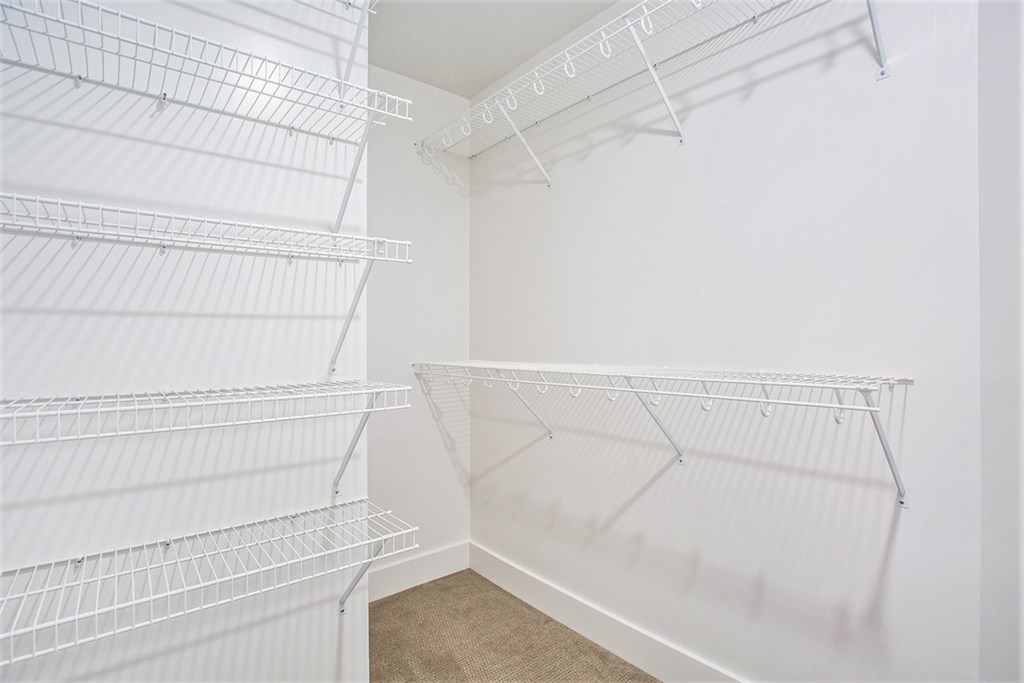 Empty white shelves in a room.