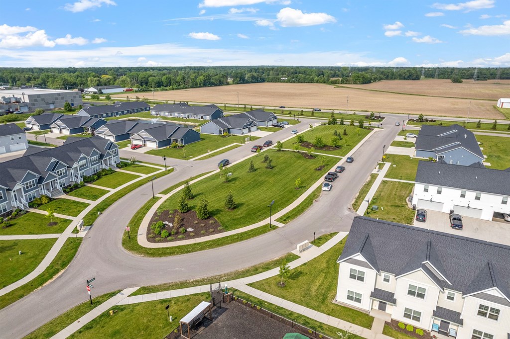 A suburban neighborhood with houses and a road.