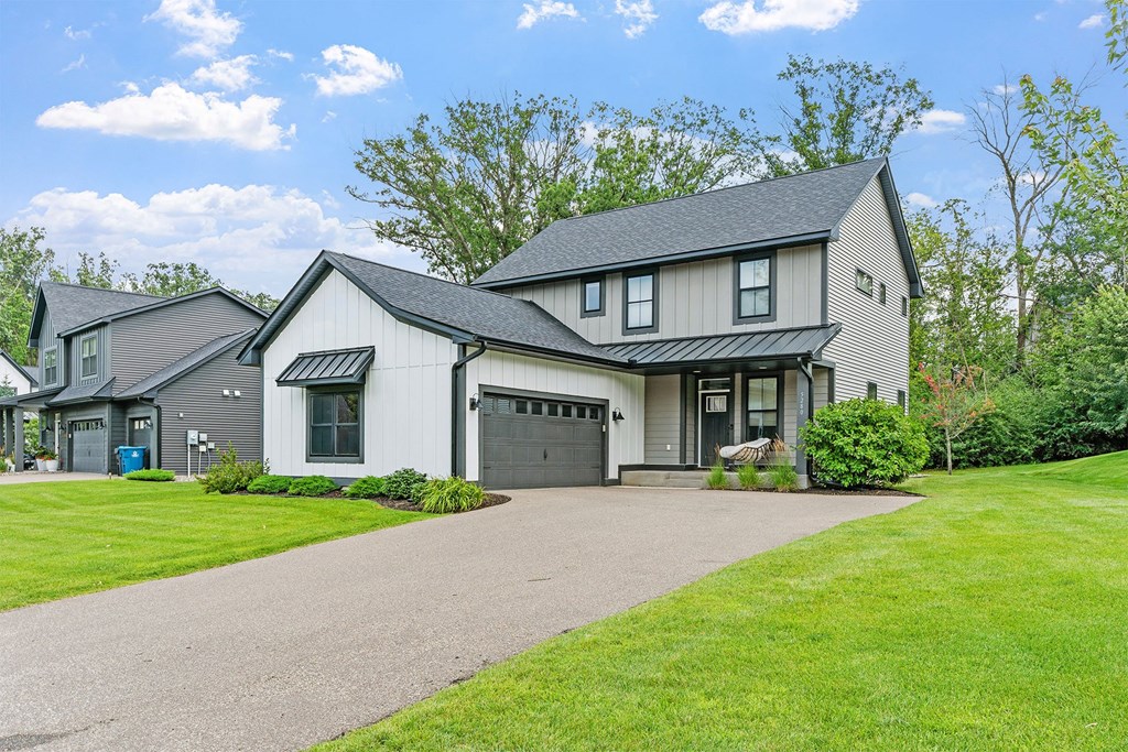 A large house with a driveway in front.