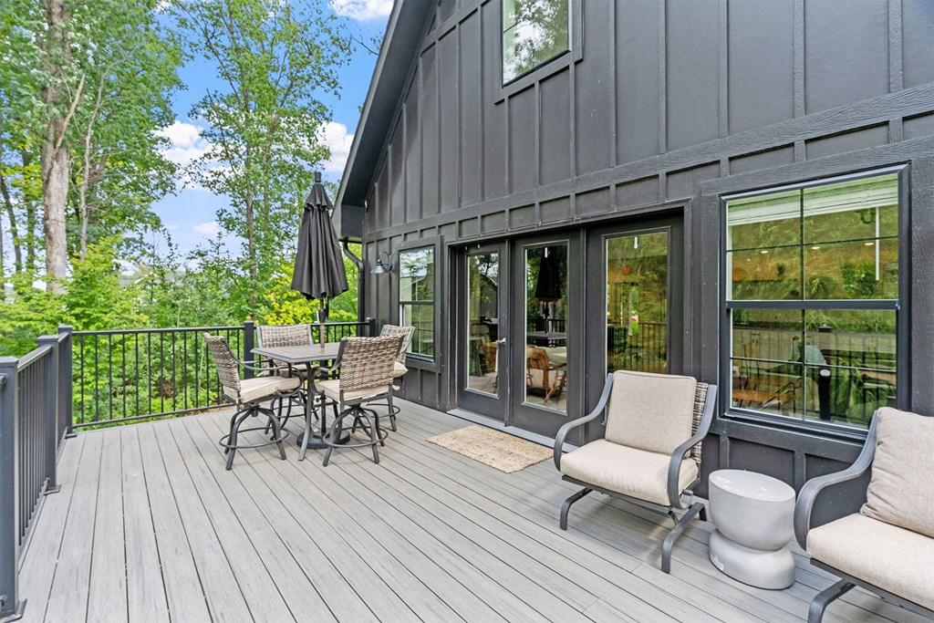 A wooden deck with a table and chairs.
