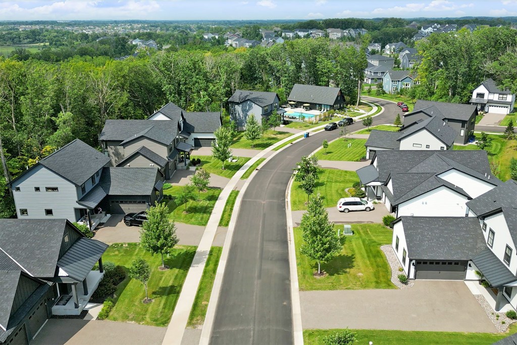 A residential area with houses and a curved road.