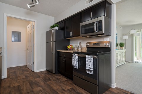 kitchen with dark wood cabinets and stainless steel appliances