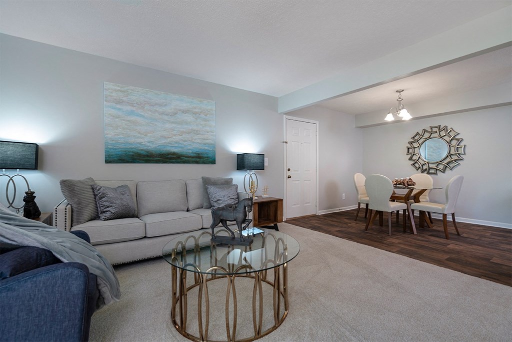 a living room and dining room with a couch and a table