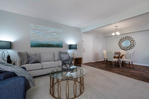 a living room and dining room with a couch and a table