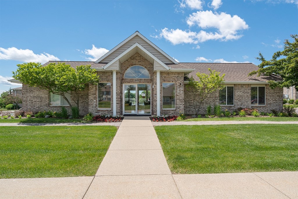 sidewalk that leads to an apartment leasing office