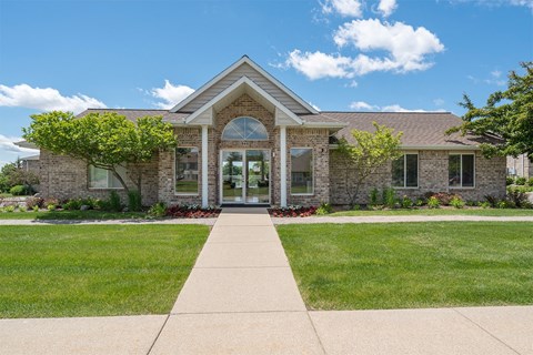 sidewalk that leads to an apartment leasing office