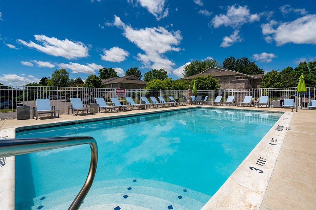large outdoor swimming pool with lounge chairs