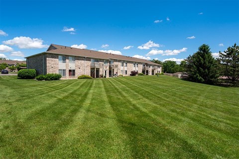 a large lawn in front of an apartment building