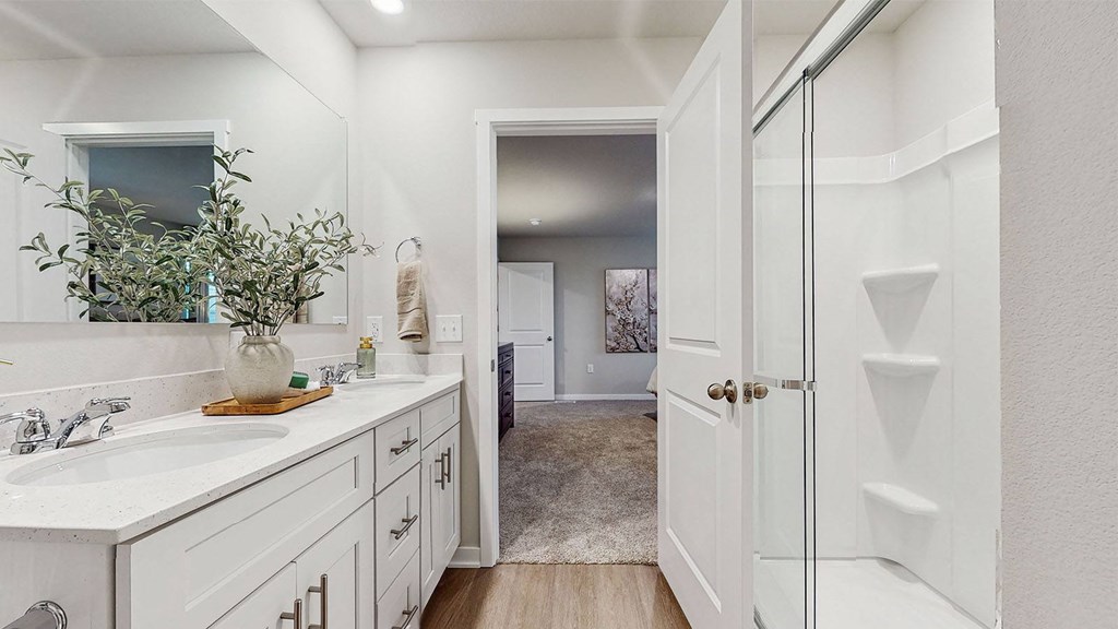 A bathroom with a white sink and a white door.