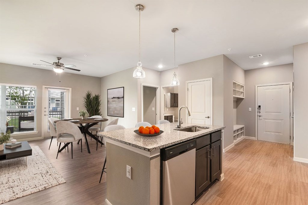A modern kitchen with a dining table and chairs.