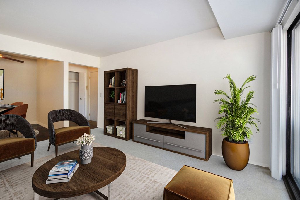 A living room with a brown coffee table and a brown ottoman.