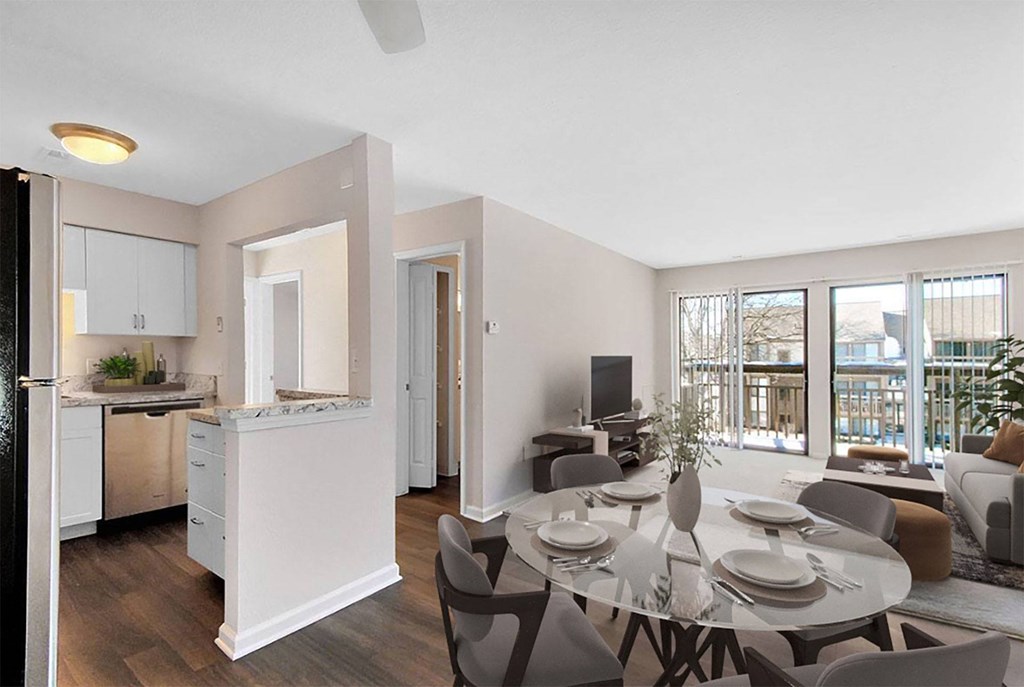A modern kitchen with a dining table set for four.