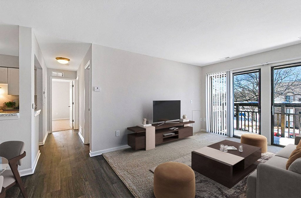 A living room with a television, a couch, and a chair.