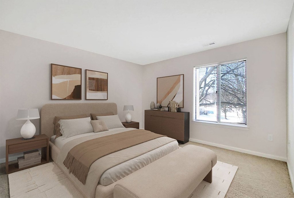 A bedroom with a large bed and two lamps on side tables.