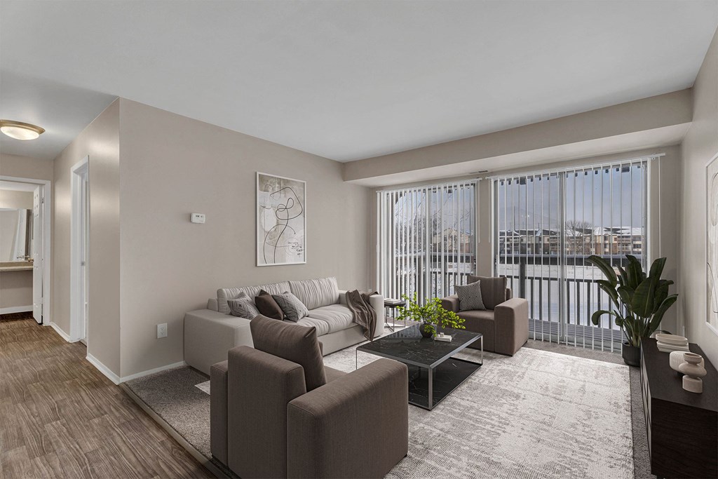 A living room with a couch, chairs, and a coffee table.