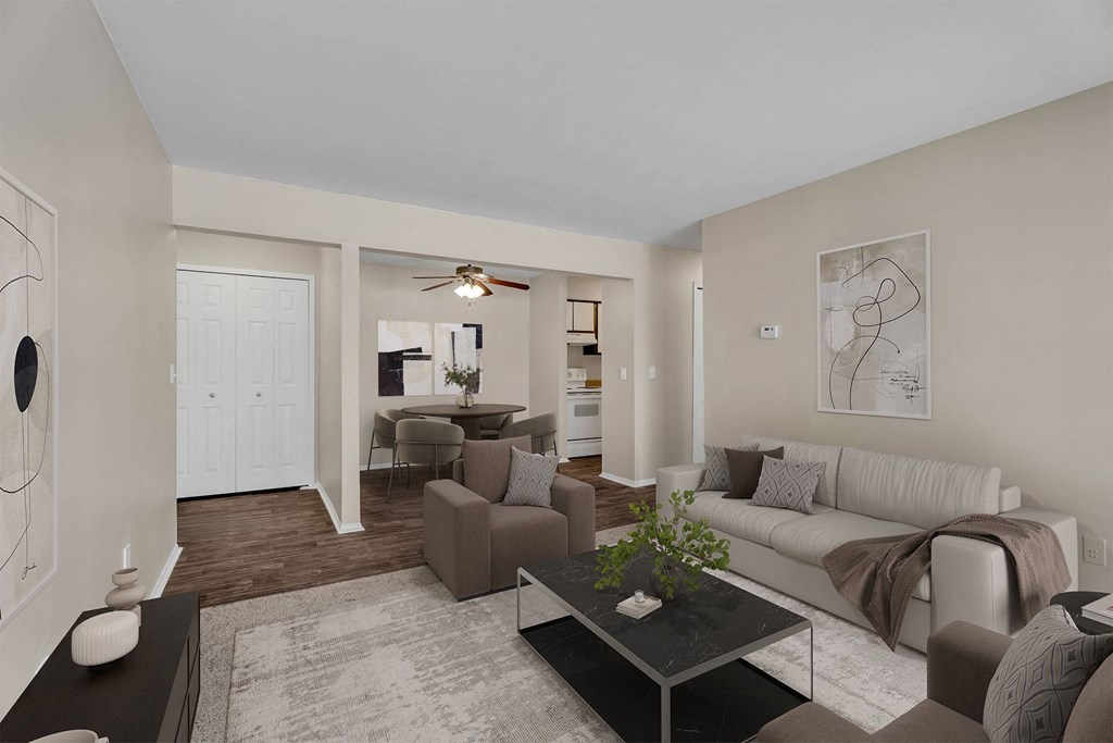 A living room with a couch, chairs, and a coffee table.