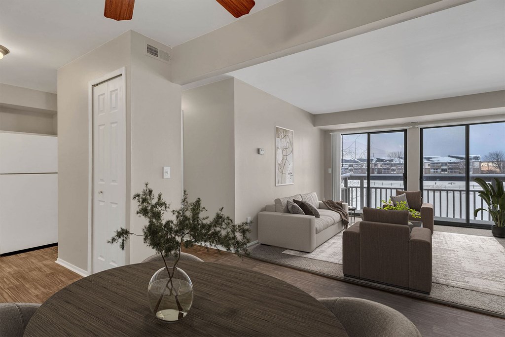 A modern living room with a brown table and a view of the city.
