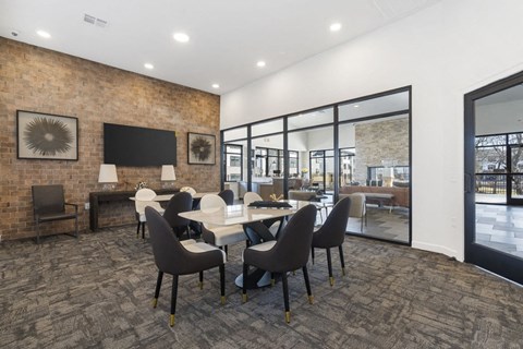 A conference room with a long table and chairs.