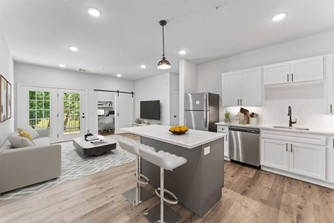 A modern kitchen with a white island and stainless steel appliances.