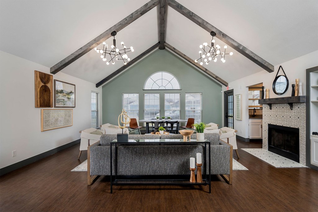 high ceiling club house with sofa and fireplace