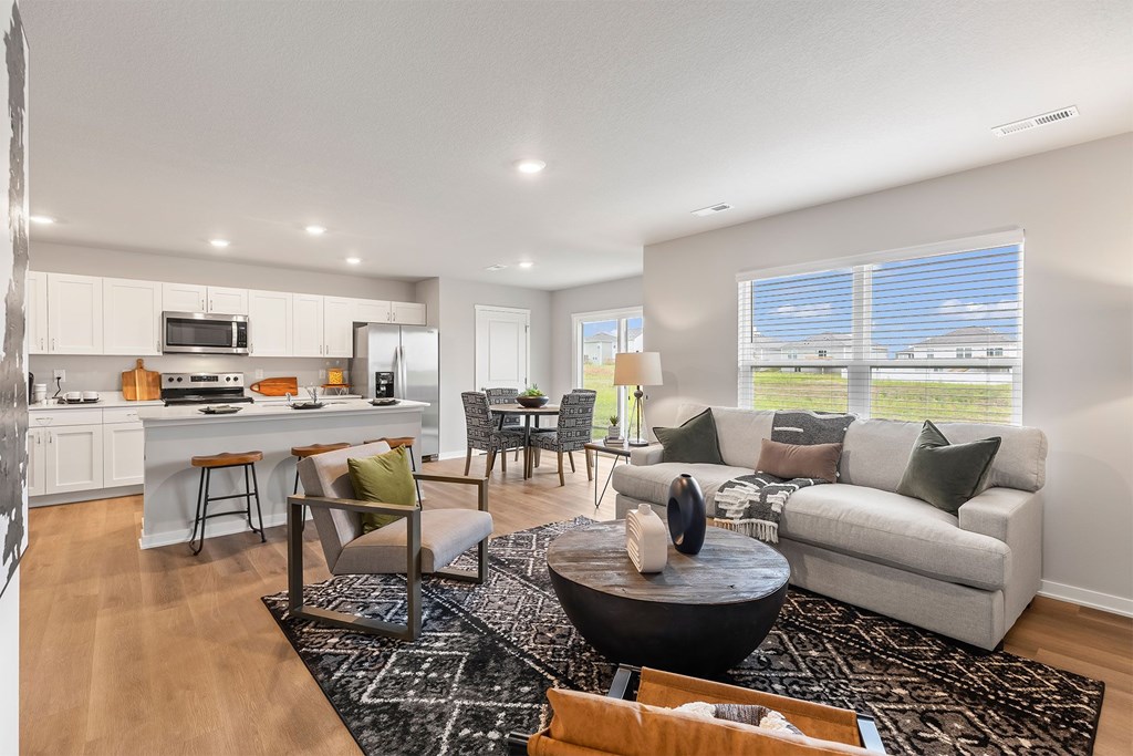 A modern living room with a black coffee table and a white couch.