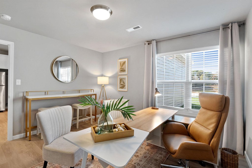 A modern dining room with a white table and chairs.