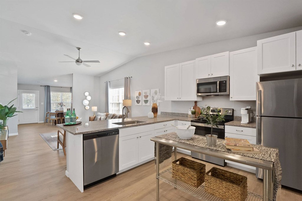 A modern kitchen with a large island and stainless steel appliances.