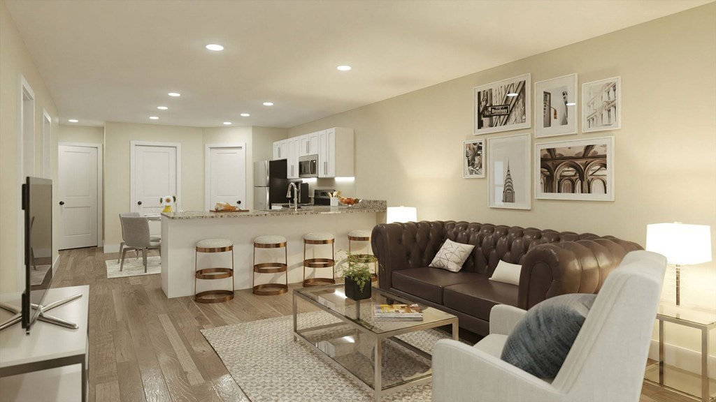 A modern living room with a brown leather couch and a television.