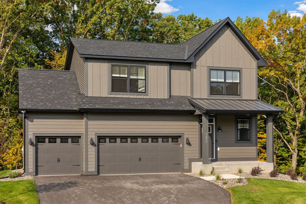 a house with two garage doors on a driveway