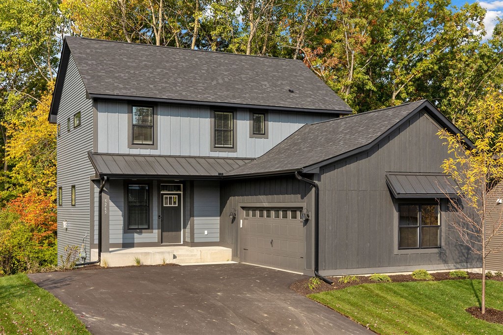 the front of a house with a garage and a driveway