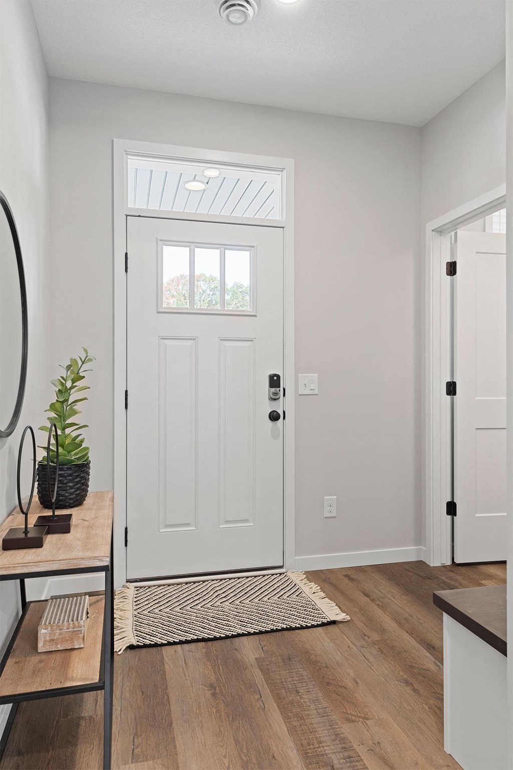 a living room with a white door and a window