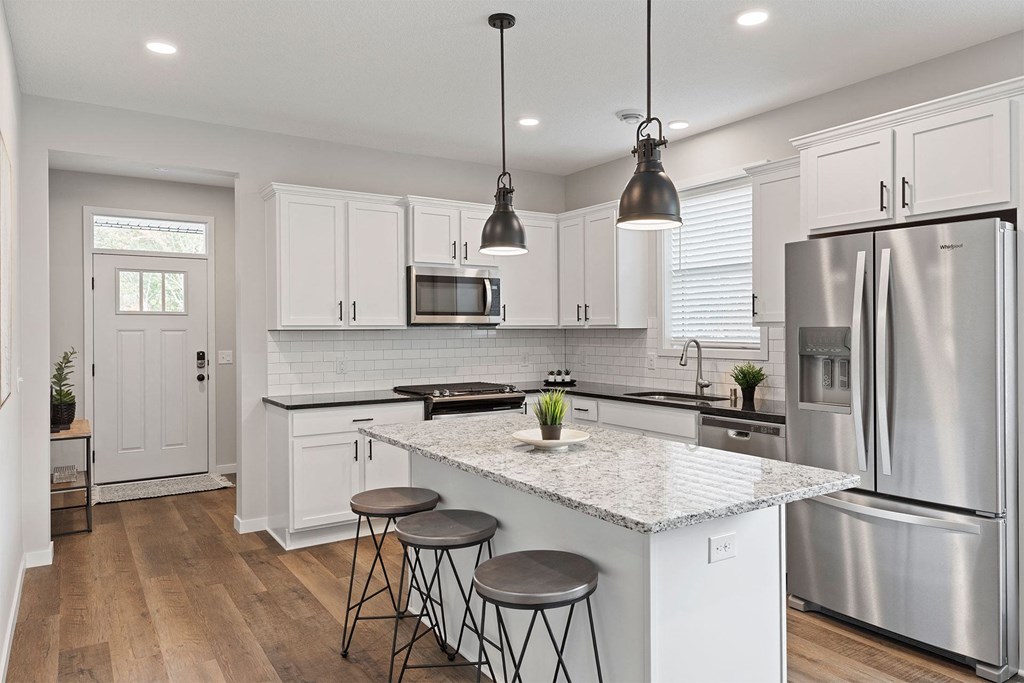 a kitchen with a marble counter top and stainless steel appliances