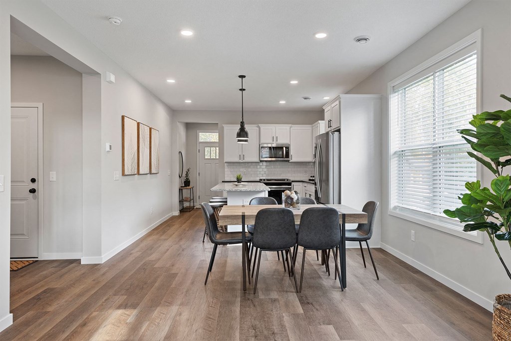 an open kitchen and dining room with a table and chairs