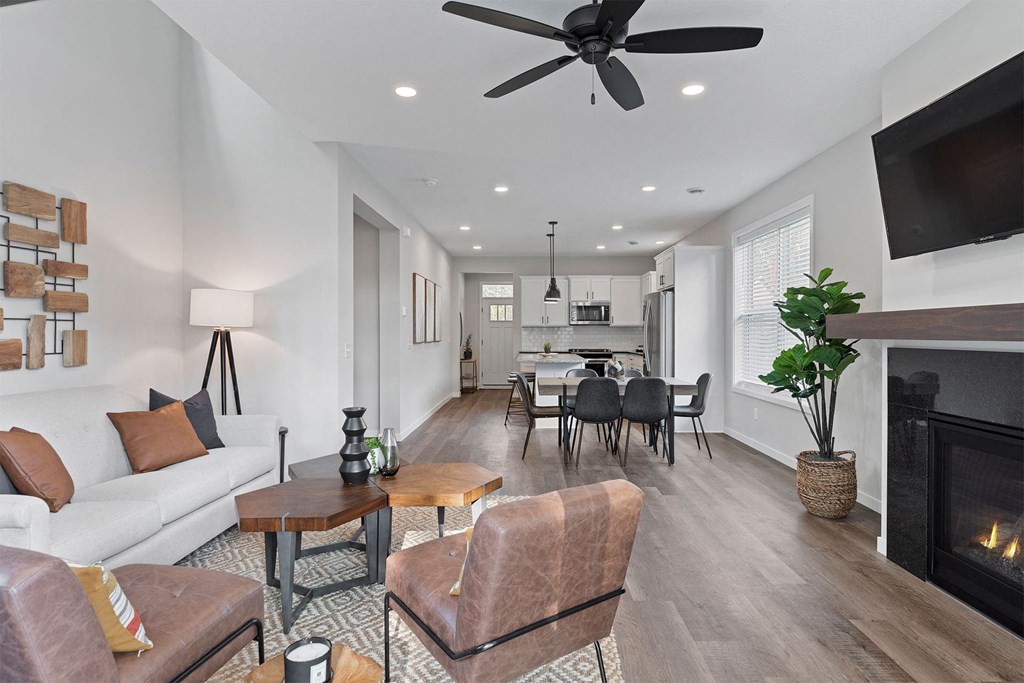 a living room with a fireplace and a table with chairs