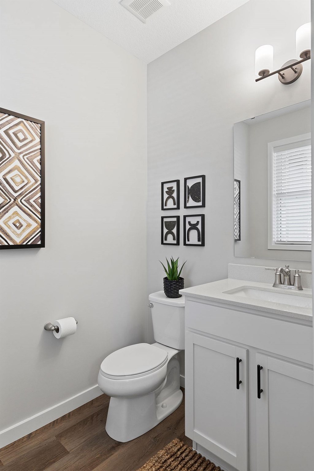 A white toilet sits next to a white sink in a bathroom.