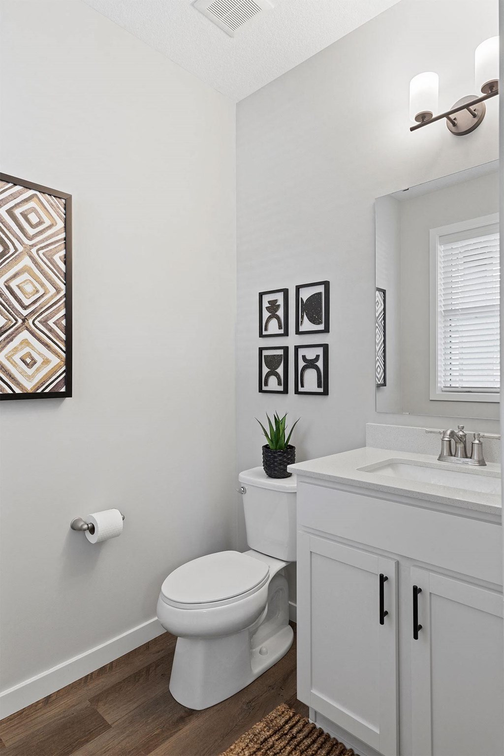 a white bathroom with a toilet and a sink