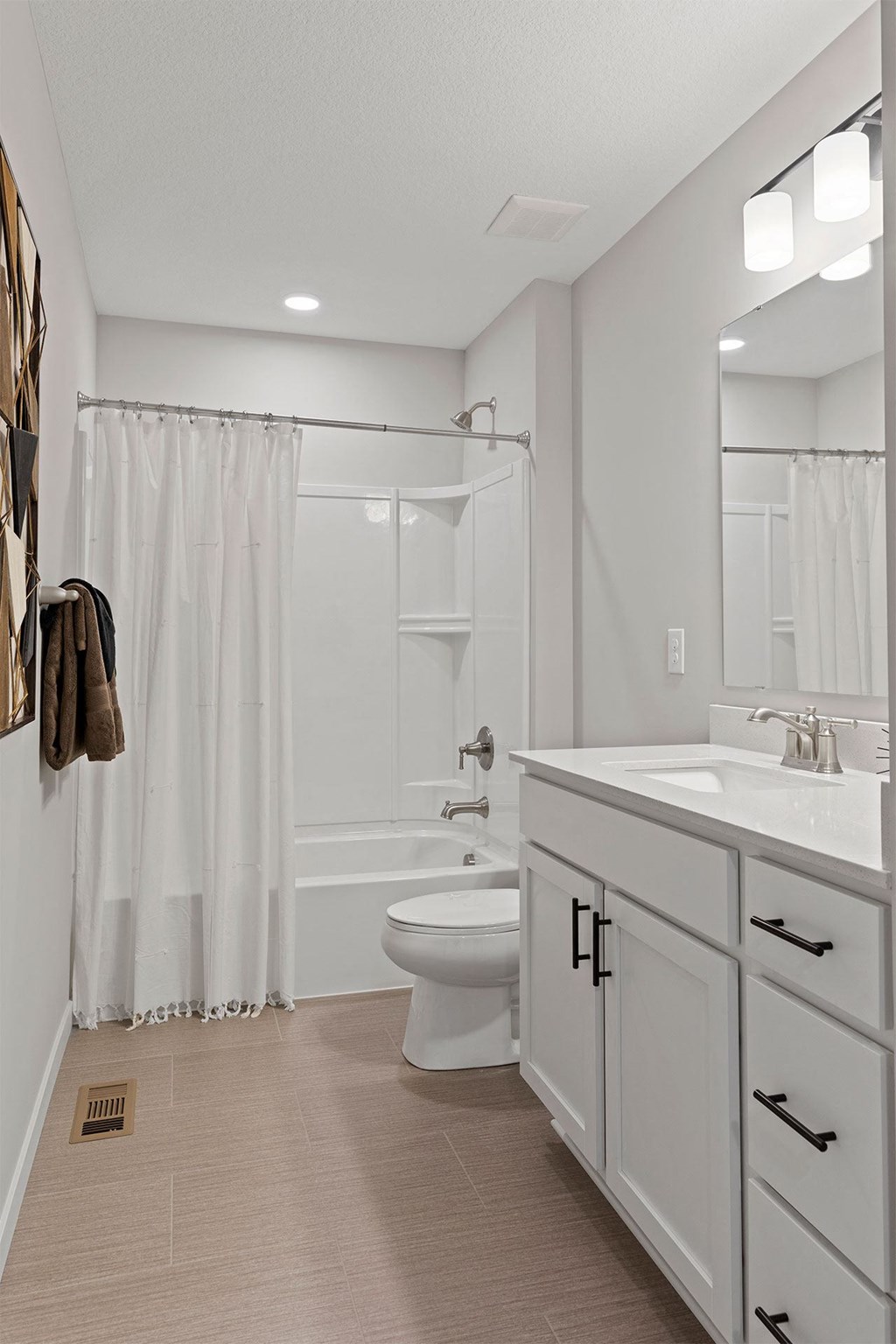 a white bathroom with a shower toilet and sink