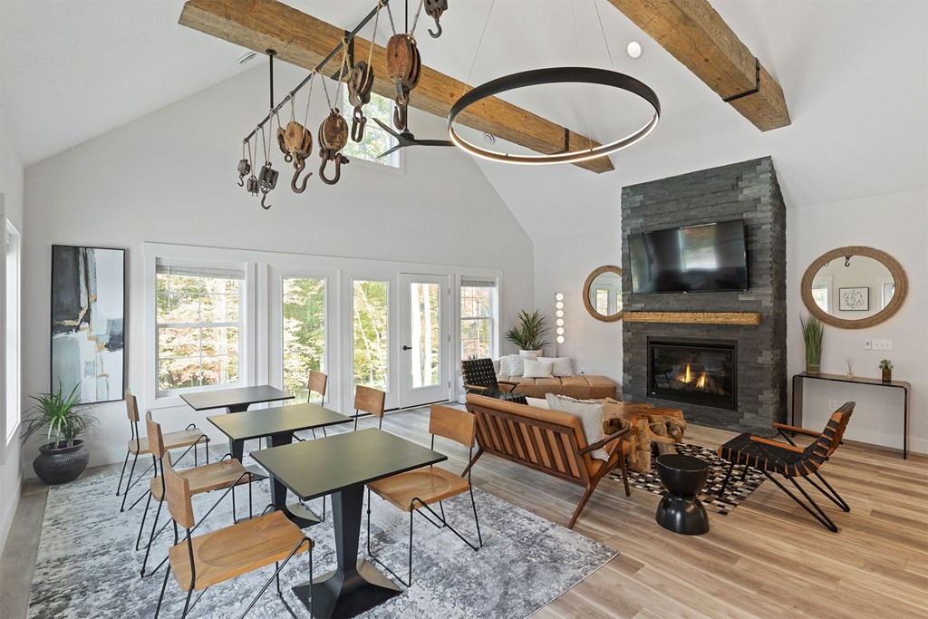 a living room with a fireplace and a table and chairs