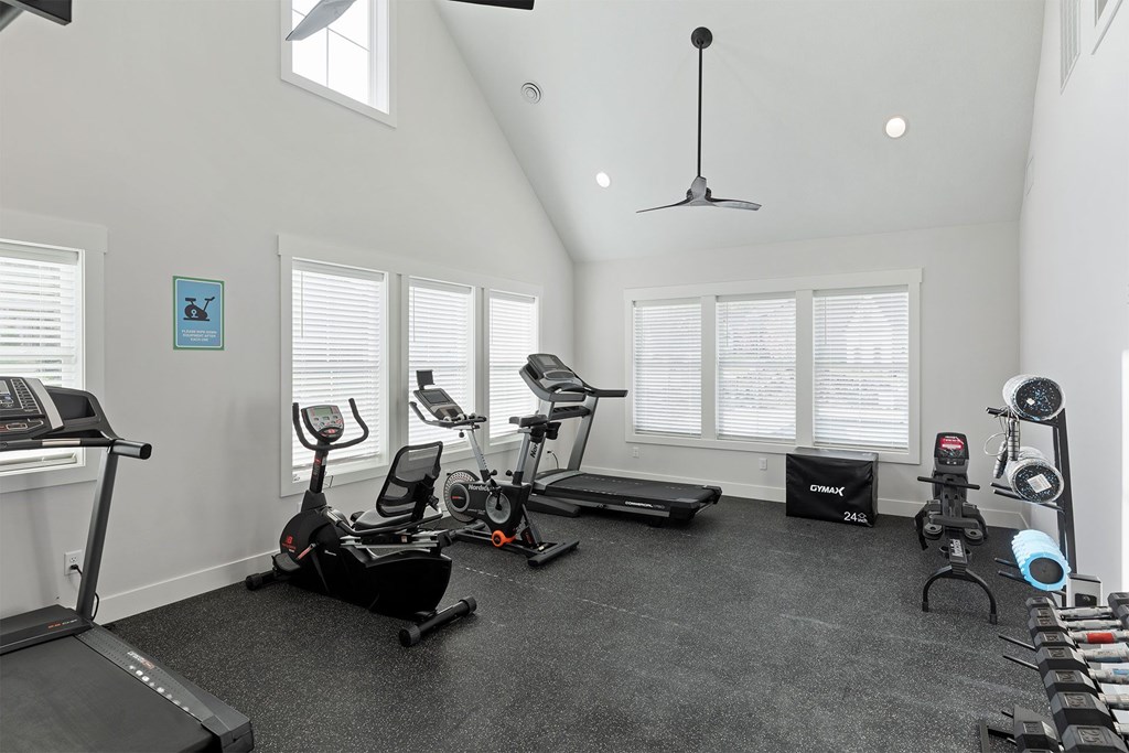 A spacious home gym with a variety of exercise equipment.