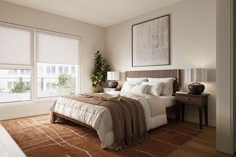A bedroom with a large bed and a plant on the side table.