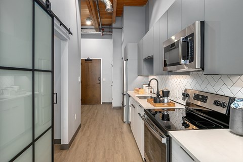 A modern kitchen with a stove top oven and a microwave.