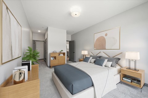 A bedroom with a large bed and a nightstand with a lamp.